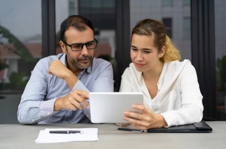 Two professionals learning and reviewing content together